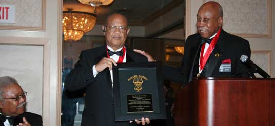 man holds plaque