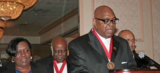 man talks at podium 