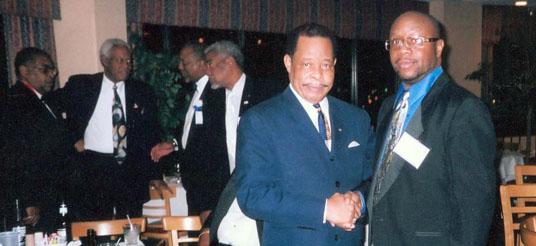 two men shake hands