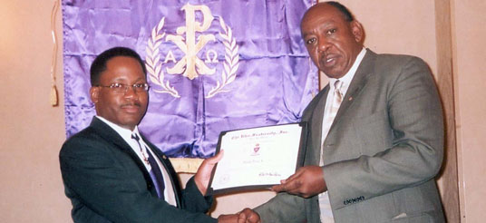 man presents certificate to another